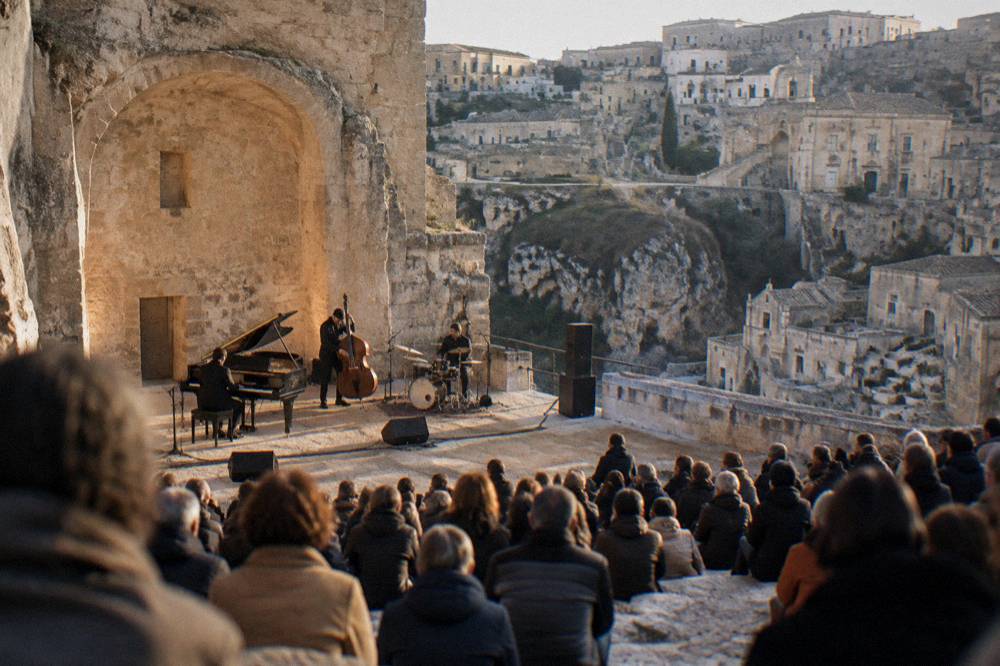 A jazz concert audience inside a stone auditorium in Matera in winter