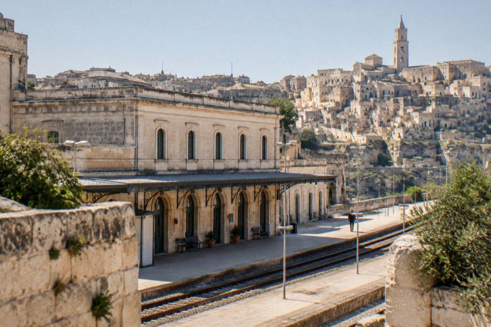 The FAL railway station building in Matera with the city skyline behind