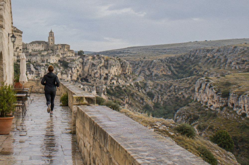 A guest terrace above the Sassi of Matera with the Murgia plateau on the far side of the canyon