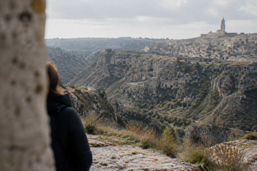 View across the Gravina canyon to rock church openings in the Murgia cliff face