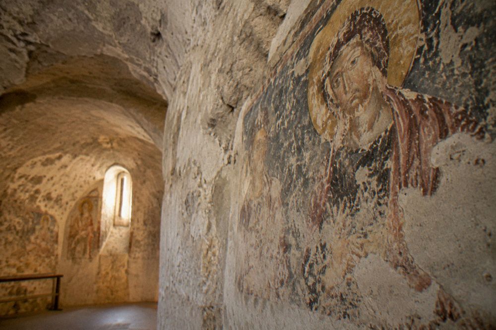 Fresco fragment on the wall of a cave church interior in Matera