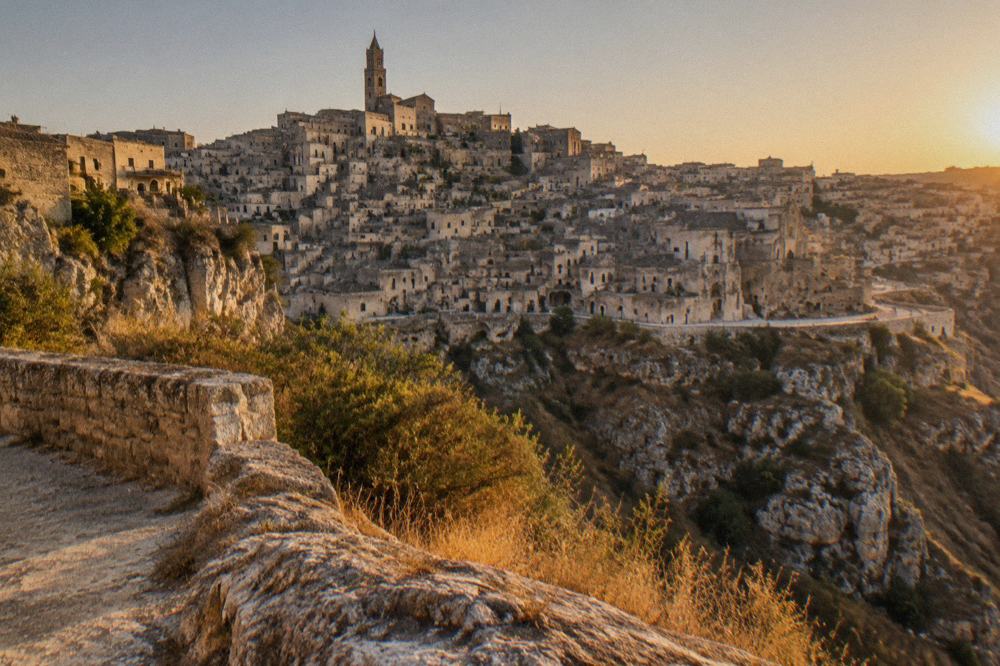 The panoramic terrace at Murgia Timone facing the Sassi skyline across the canyon at golden hour