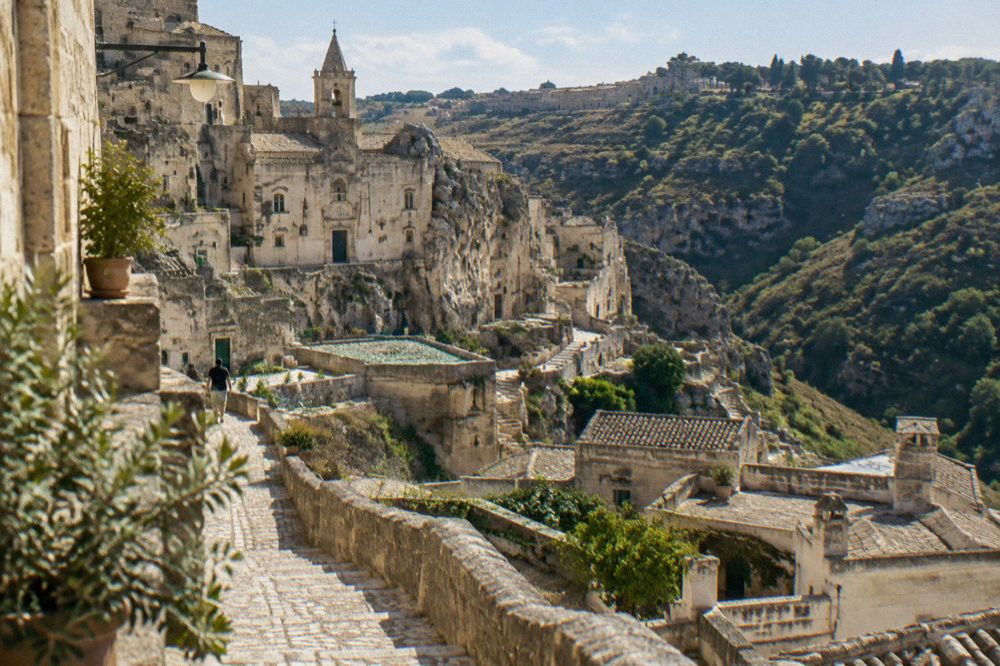 Stone houses of a hill village perched on a wooded ridge in the Lucanian mountains