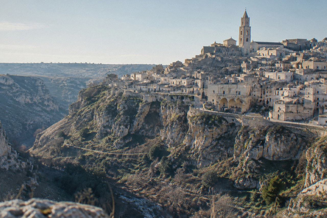 The Sassi cave dwellings of Matera under a pale winter sky, seen from across the Gravina canyon
