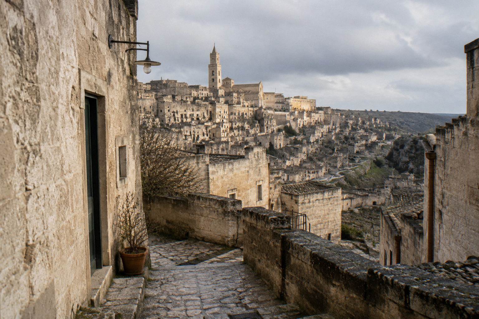 Grey winter sky over the Sassi, damp stone and bare lanes, no people in focus