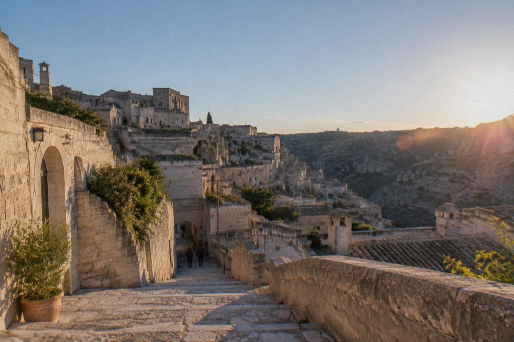 Pale limestone buildings and a stone stairway descending into the Sasso Barisano district of Matera