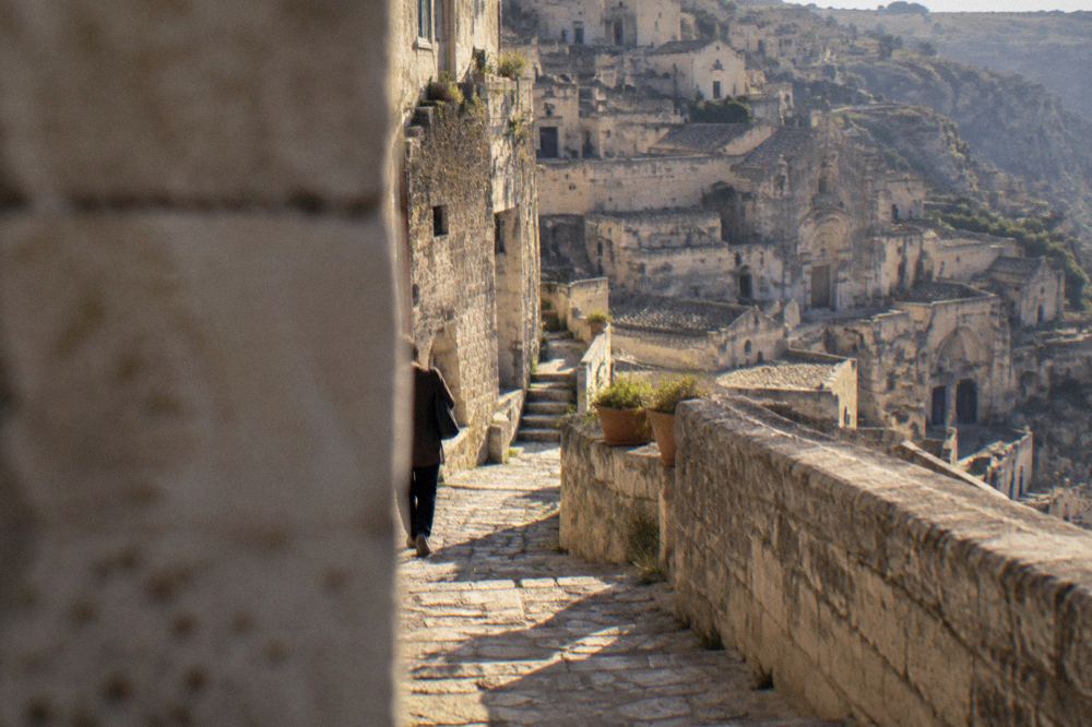 A street sign marking a limited traffic zone on a stone street in central Matera