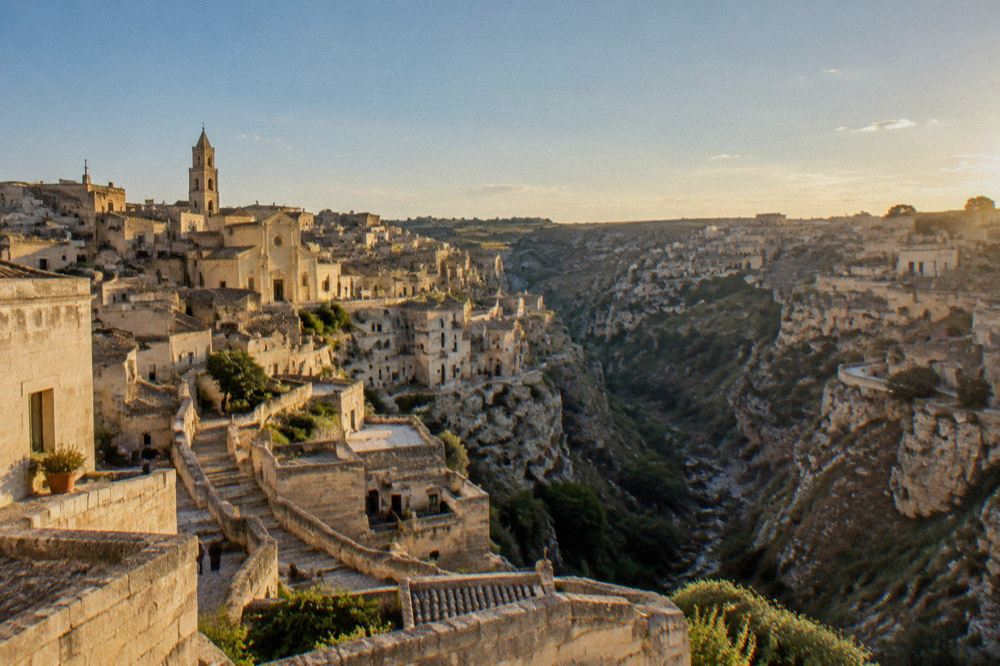 Evening light over the rooftops and cave dwellings of Matera seen from above the canyon