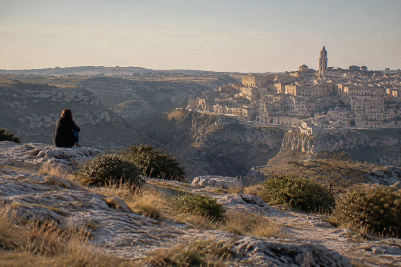The Sassi cave dwellings of Matera rising above the Gravina canyon at golden hour