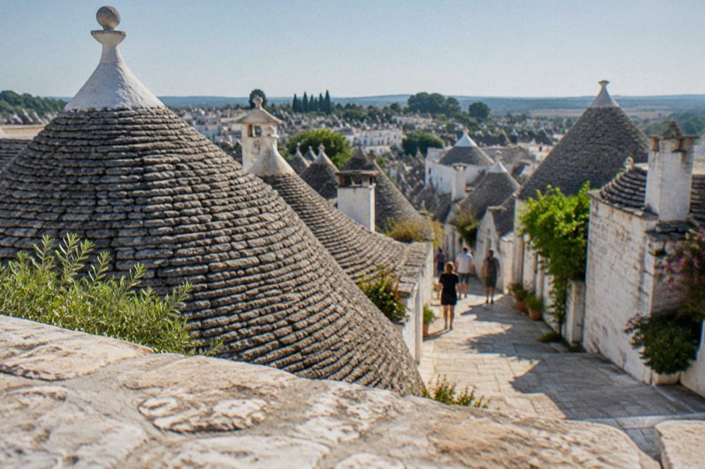 The conical trulli roofs of Alberobello seen from a terrace above the town
