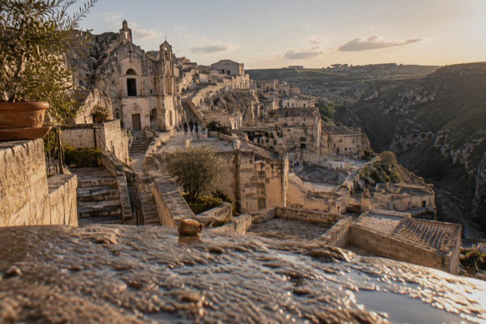 The Sassi of Matera lit warm by the last sun with long shadows across the terraced rooftops