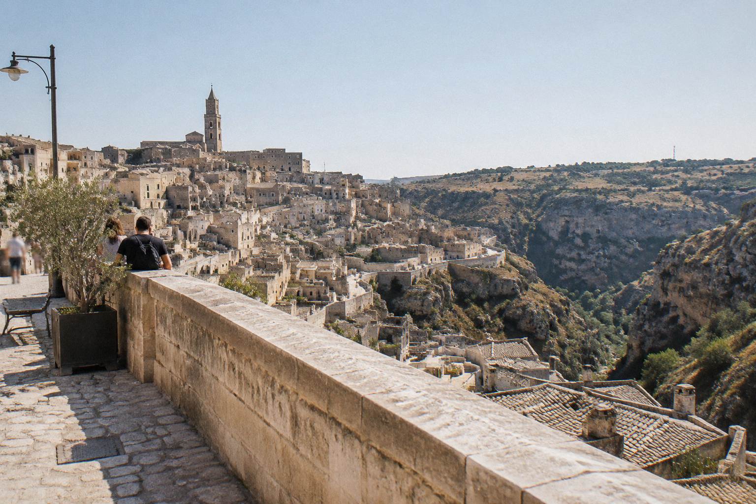 Stone-railed viewpoint terrace looking over the rooftops and gorge of Matera