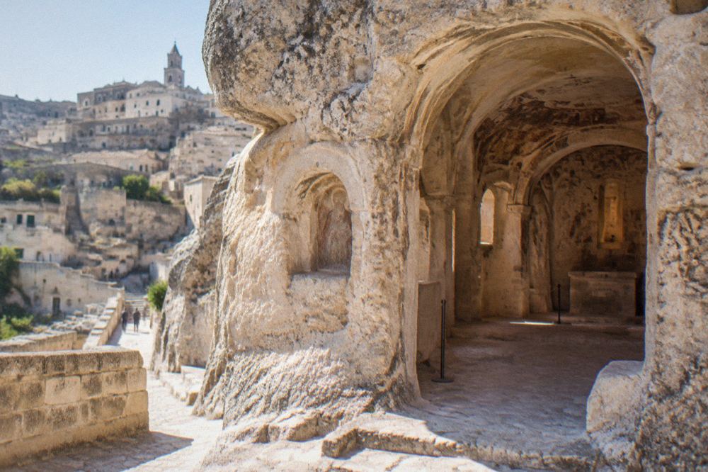 Stone facade and carved interior of a rock church in the Sassi of Matera