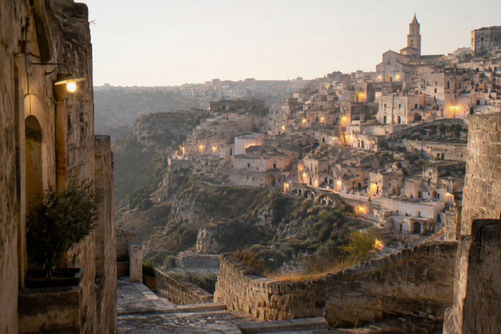 Evening lights glowing in the cave houses across the Sassi district of Matera after dark