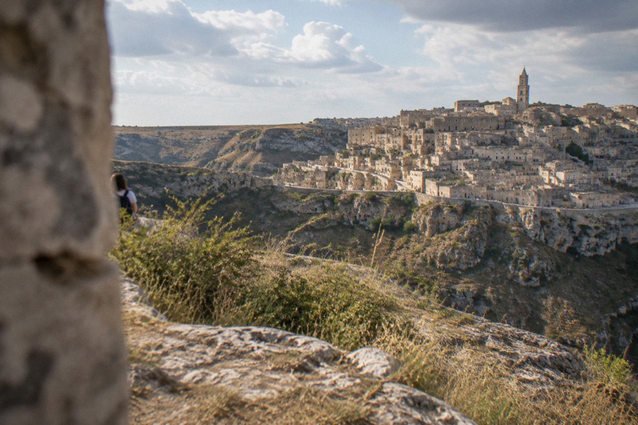 View over the cave houses and rock churches of the Sassi districts of Matera from across the Gravina canyon