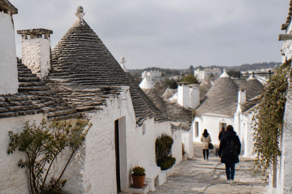 Whitewashed trulli houses with conical stone roofs in Alberobello