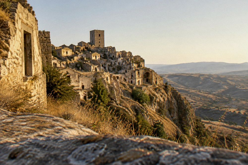 The abandoned stone houses of the ghost town Craco on a hillside