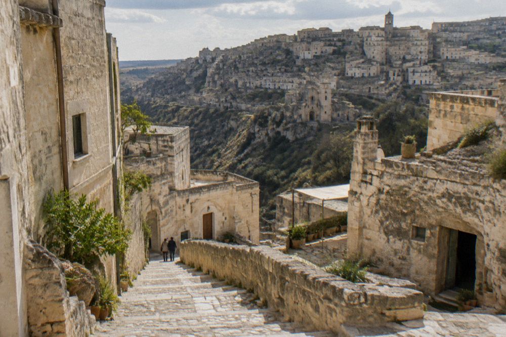 A narrow stepped stone lane between cave dwellings in the Sassi of Matera