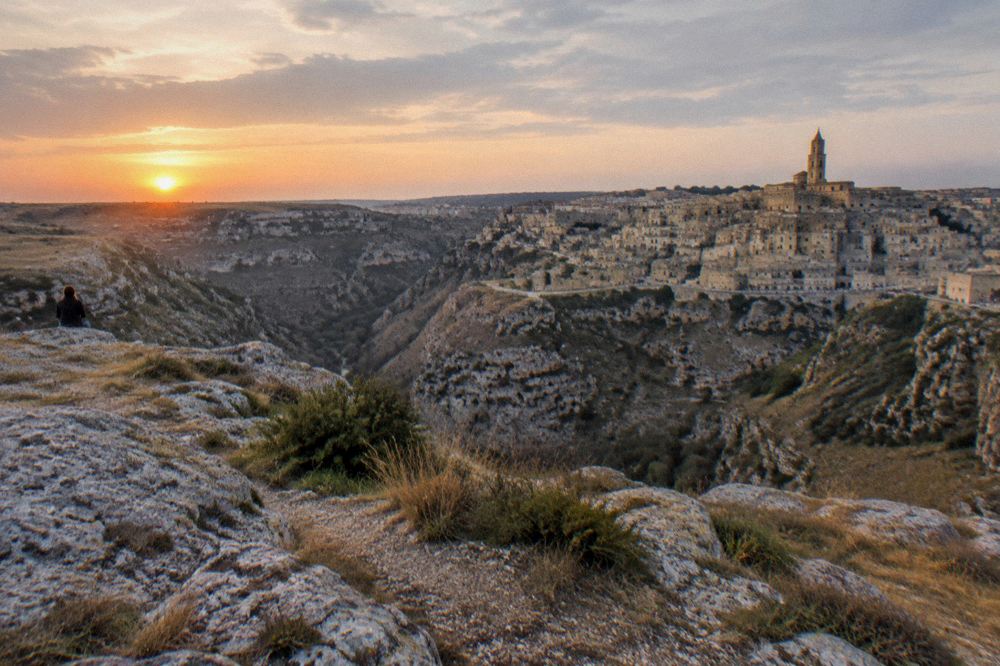 A sunset view over the cave quarters of Matera from a viewpoint across the Gravina canyon