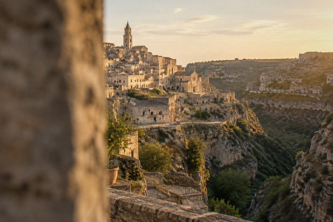 The Sassi district of Matera seen from across the Gravina canyon at golden hour