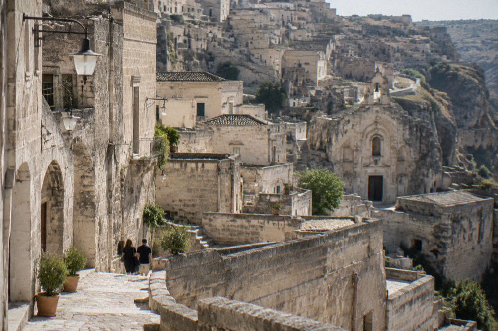 Terraced stone street in the Sassi with lanterns lighting an evening walk