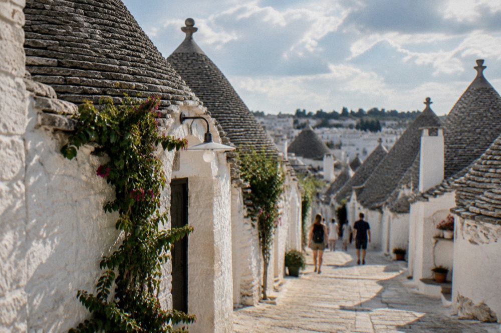 Rows of whitewashed trulli with conical stone roofs on Rione Monti in Alberobello