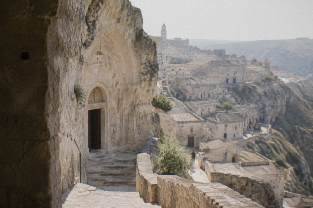 A rock-cut church doorway carved into pale limestone in the Sassi district