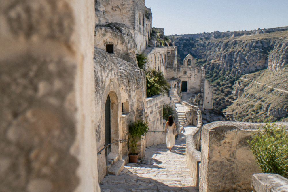 Stone stairs and cave doorways stacked along a lane in the Sasso Caveoso district