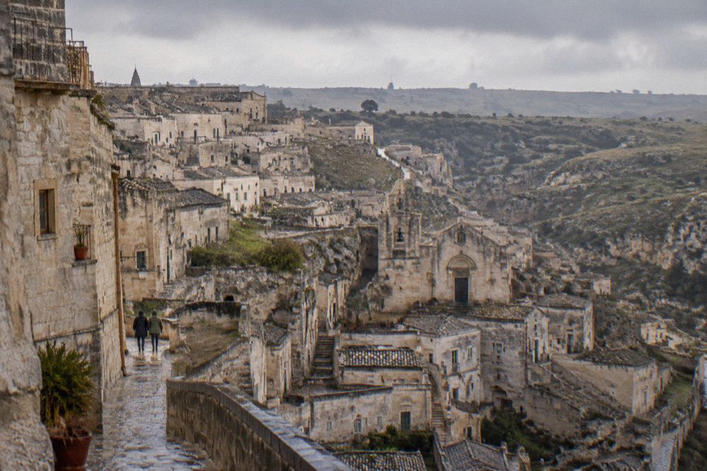 Rain clouds passing over the rooftops of Matera with the Murgia plateau on the horizon