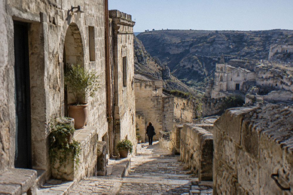 A narrow stepped lane between stone houses in Sasso Caveoso in the morning