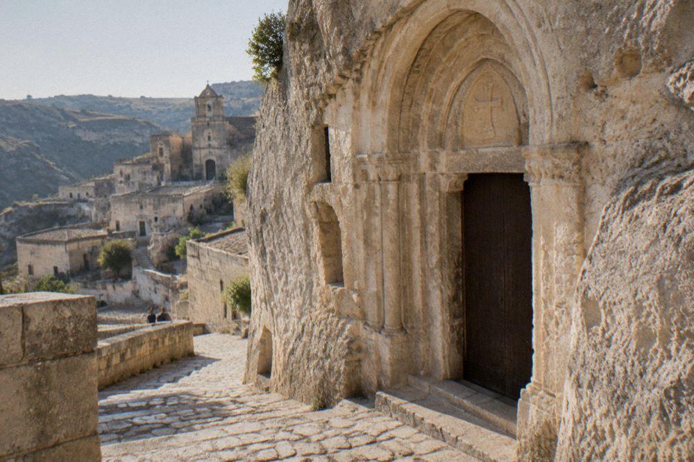 Stone facade of a rock-cut church entrance in the Sassi districts of Matera