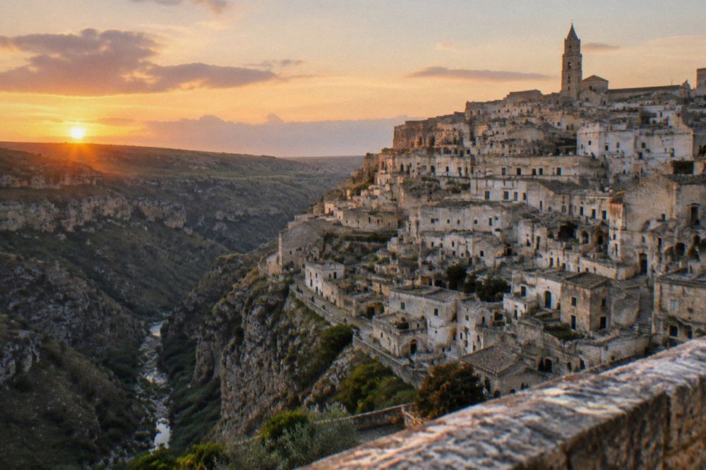Sunset over the Sassi rooftops seen from a viewpoint across the Gravina canyon