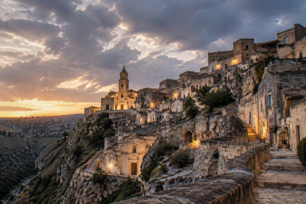 Twilight over the illuminated Sassi of Matera seen from a canyon viewpoint
