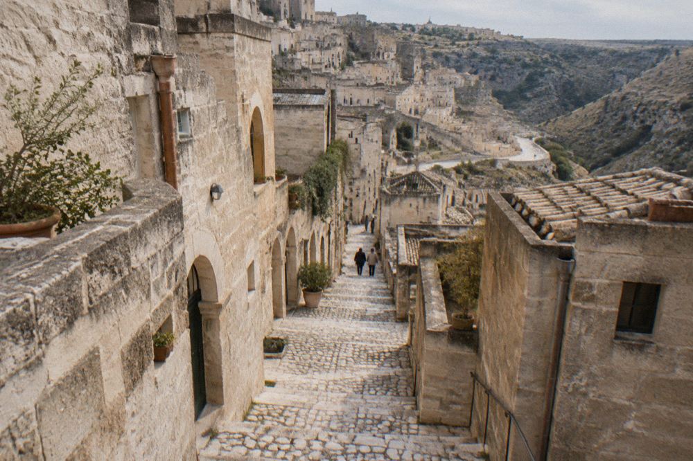 A narrow stepped lane between stone houses in the Sasso Barisano district of Matera
