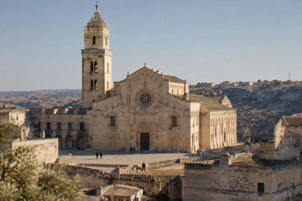 The carved stone facade of Matera Cathedral seen from the Civita ridge