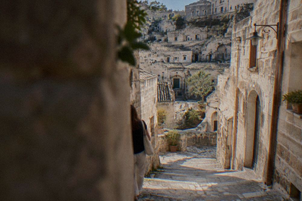 A narrow stepped lane between pale stone houses in the Sasso Barisano district of Matera