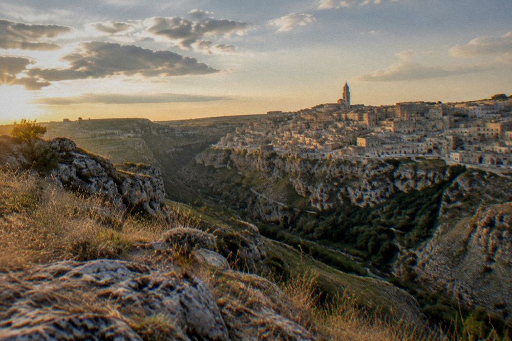 A panoramic view of the Sassi districts from the Murgia side of the Gravina canyon at golden hour