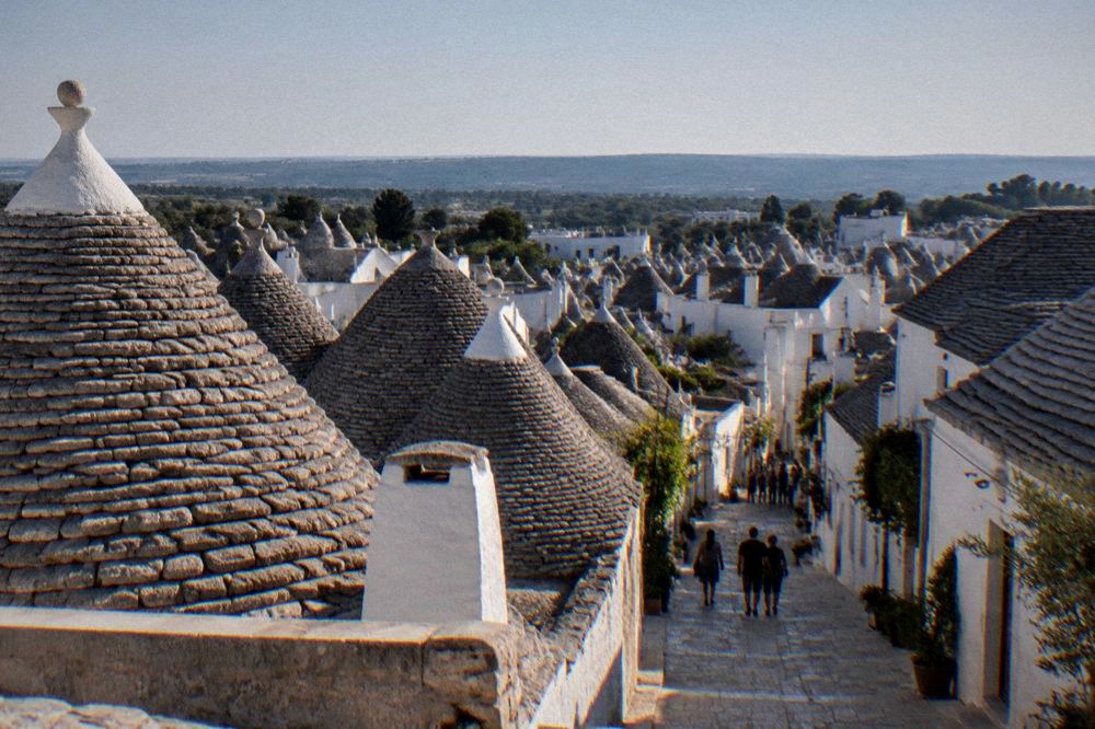 White trulli rooftops of Alberobello seen from above on a clear day