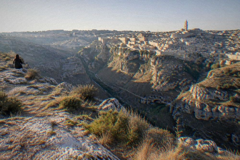 The view across the Gravina canyon from a Murgia plateau viewpoint towards the Sassi