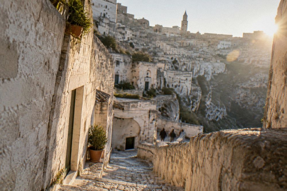 A steep stone staircase between whitewashed cave houses in the Sassi